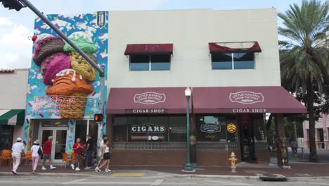 Street-view-of-colorful-buildings,-including-a-cigar-shop-and-an-ice-cream-shop,-in-Little-Havana,-Miami,-USA