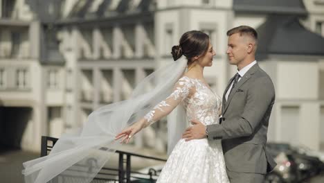 Lovely-newlyweds-caucasian-bride-embracing-groom-making-kiss,-wedding-couple-family-hugging-together