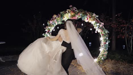 Newlyweds.-Caucasian-groom-with-bride-near-acres-of-flowers.-Night-time