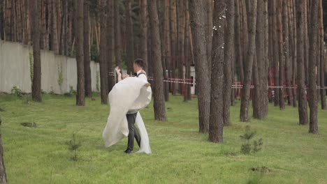 Lovely-newlyweds-caucasian-bride-groom-dancing-in-park,-making-kiss,-wedding-couple-family