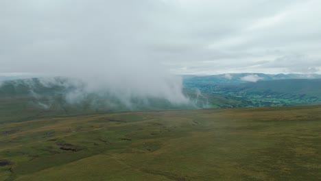 Drone-view-of-Whernside-tarns-covered-in-fog-on-a-foggy-day-in-Yorkshire-dales-in-England