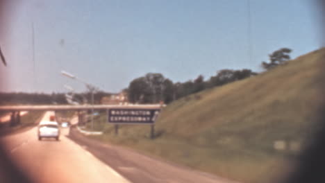 Classic-Car-Travels-Washington-Highway-on-Sunny-Day-in-1950s