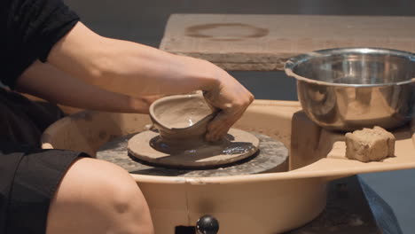 Unrecognizable-Creative-Artist-Molding-Clay-On-Pottery-Wheel,-Workshop-Ceramic-Studio