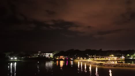 Aerial-night-time-view-of-coast-line-over-the-Parana-river-in-city-of-Posadas