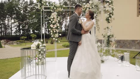 Newlyweds,-caucasian-groom-with-bride-walking,-embracing,-hugs-in-park,-wedding-couple