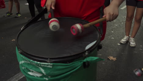 close-up-shot-of-drums-during-abortion-rally,-Women's-day,-performers-pound-rubber-drum-sticks-mallets-on-drums