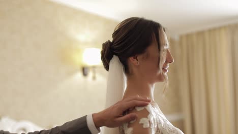 Newlyweds-young-caucasian-bride-and-groom-first-meeting-at-wedding-day,-making-a-kiss-indoors