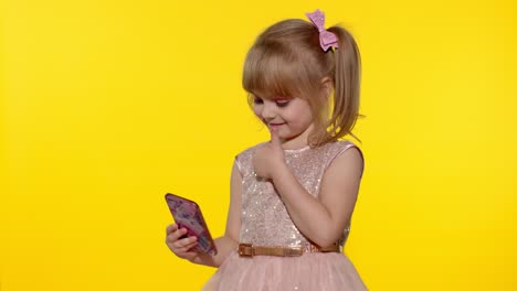 Child-girl-using-smartphone.-Portrait-of-blonde-kid-emotionally-makes-selfie-on-mobile-phone