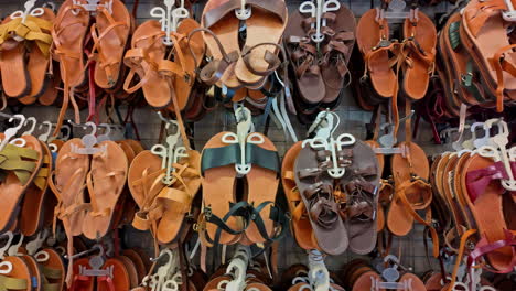 Brown-Sandals-lined-up-in-a-shop-in-athens-greece,-closeup