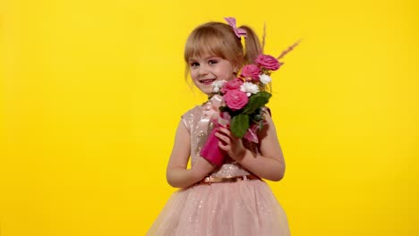 Little-child-girl-with-fashion-makeup-standing-with-bouquet-of-flowers-isolated-on-yellow-background