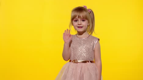 Friendly-little-blonde-child-kid-girl-waving-to-the-camera-doing-hello-or-bye-gesture,-slow-motion