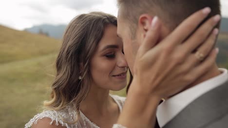 Lovely-caucasian-wedding-newlyweds-family-bride-groom-walking,-making-a-kiss-on-mountain-slope-hill