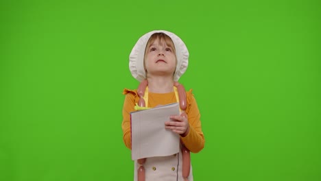 Child-girl-kid-cook-chef-writing-with-pen-in-notebook-new-recipe-standing-over-chroma-key-background