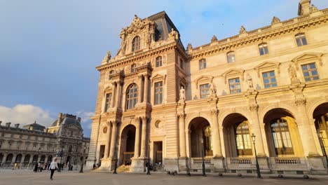 Pavillon-Mollien-and-other-historical-buildings-with-tourists-as-part-of-the-Louvre-Palace-on-a-late-summer-afternoon-in-Paris,-France