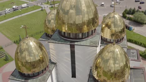 Dome-of-the-church,-aerial-view,-traditional-old-church-in-Lviv,-Ukraine-city,-cloudy-blue-sky