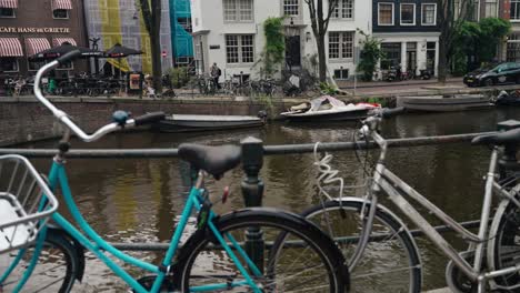 Bicycles-On-The-Canal-Bridge-In-Amsterdam,-Netherlands,-Europe