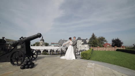 Lovely-newlyweds-caucasian-bride-embracing-groom-in-park-making-kiss,-wedding-couple-family-hugging