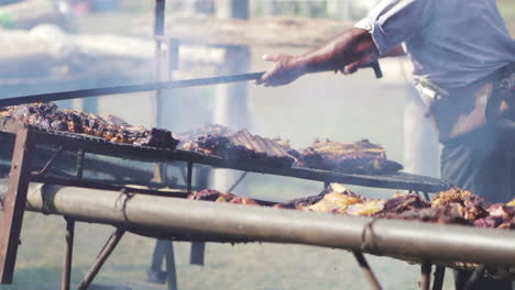 Man-cooking-meat-on-traditional-South-American-barbecue