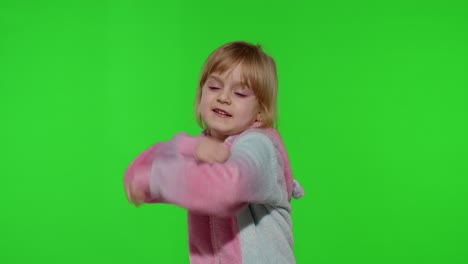 Little-blonde-child-girl-smiling,-dancing,-celebrating-in-unicorn-pajamas-costume-on-chroma-key