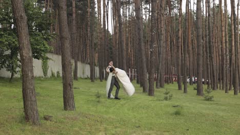 Lovely-newlyweds-caucasian-bride-groom-dancing-in-park,-making-kiss,-wedding-couple-family