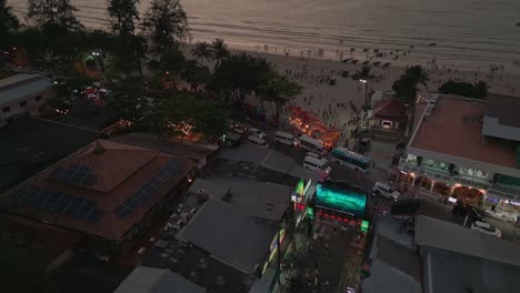 Drone-shot-of-tourists-at-Bangla-road-and-Patong-Beach-enjoying-vacation-in-Phuket,-Thailand