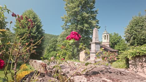 Pretty-scene-Bulgarian-rustic-village,-flowers-and-church-tower