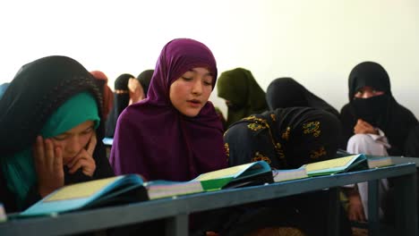 Muslim-Afghan-girls-studying-the-Quran,-a-hijab-wearing-girl,-a-Muslim-girl-in-prayer