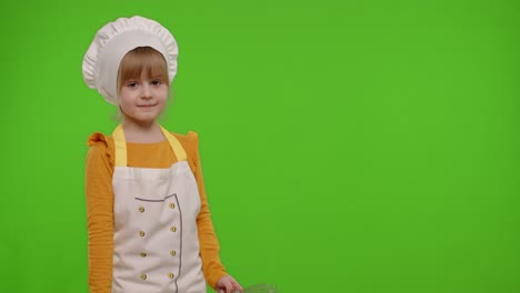 Girl-kid-dressed-as-cook-chef-baker-posing,-smiling,-looking-at-camera-on-chroma-key-background