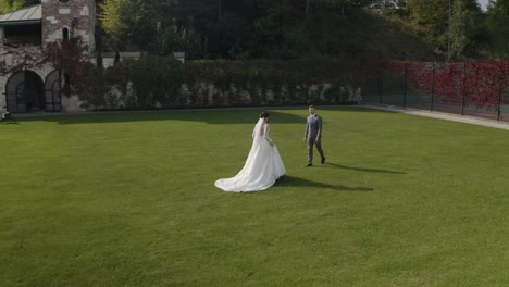 Lovely-newlyweds-caucasian-bride-groom-walking-in-park,-holding-hands,-wedding-couple-family