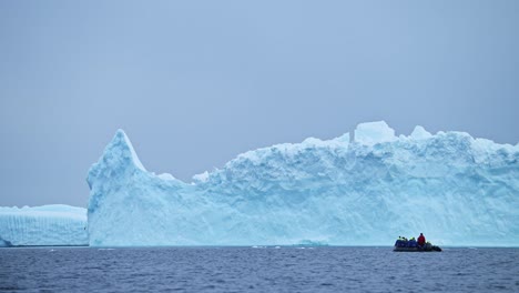 Antarctica-Boat-Trip-and-Iceberg-Scenery-in-Winter-Ice-on-Antarctic-Peninsula,-Tourists-People-Traveling-in-Beautiful-Dramatic-Landscape-on-Zodiac-Boat-Tour,-a-Unique-Adventure-Travel-Experience