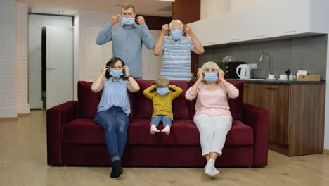 Coronavirus-quarantine-lockdown-concept.-Family-puts-medical-protective-masks-on-faces-at-home