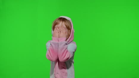 Little-blonde-child-in-unicorn-costume-crying,-wiping-tears-with-her-hands-on-chroma-key-background