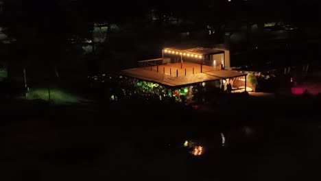 Aerial-nightlife-view-of-outdoor-club-full-of-people