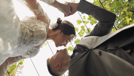 Lovely-newlyweds-caucasian-bride-embracing-groom-in-park-making-kiss,-wedding-couple-family-hugging