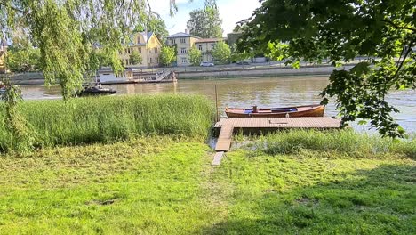 Motorboat-drives-on-Emajogi-river-in-Tartu-on-sunny-day