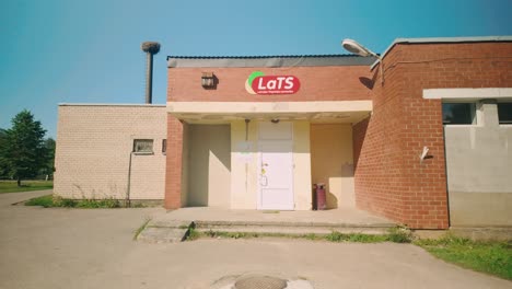 Facade-of-a-Latvian-supermarket-Lats-with-a-visible-stork-nest-in-the-background