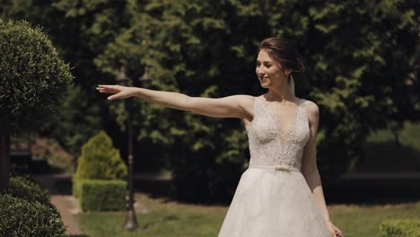 Newlyweds,-caucasian-groom-with-bride-walking,-embracing,-hugs-making-a-kiss-in-park,-wedding-couple