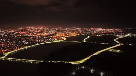 Panoramic-nighttime-aerial-view-over-the-city-in-lights