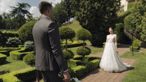 Lovely-newlyweds-caucasian-bride-and-groom-with-bouquet-in-park,-wedding-couple-first-meeting