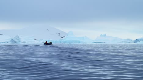 Antarctica-Boat-Trip-and-Iceberg-Scenery-in-Winter-Ice-on-Antarctic-Peninsula,-Tourists-People-Traveling-in-Beautiful-Dramatic-Landscape-on-Zodiac-Boat-Tour,-a-Unique-Adventure-Travel-Experience