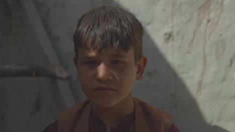 An-Afghan-boy-in-need,-looking-sad-at-the-camera,-Orphan-in-need