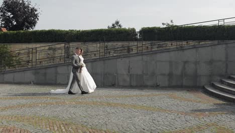 Lovely-newlyweds-caucasian-bride-groom-walking-in-park,-holding-hands,-wedding-couple-family