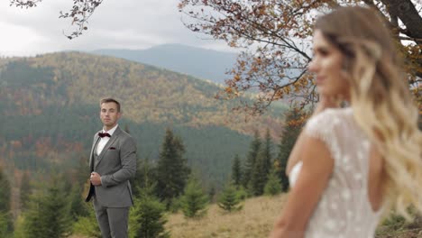 Lovely-caucasian-wedding-couple-newlyweds-family-bride-groom-stay-together-on-mountain-slope-hill