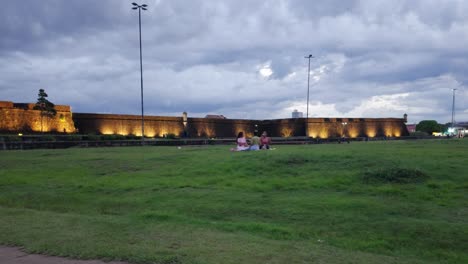 Stroll-along-Macapá's-waterfront-by-the-gardens-and-people-having-leisure,-with-the-São-José-de-Macapá-Fortress-visible-in-the-distance