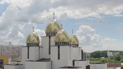 Dome-of-church,-aerial-view,-traditional-old-church-in-city-Lviv,-Ukraine,-cloudy-sky-background