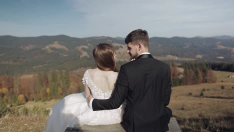 Newlyweds.-Caucasian-groom-with-bride-on-mountain-slope.-Wedding-couple.-Happy