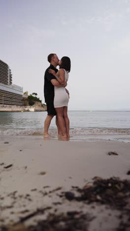 Vertical-view-of-loving-couple-kiss-and-hug-near-tropical-beach-in-Mallorca