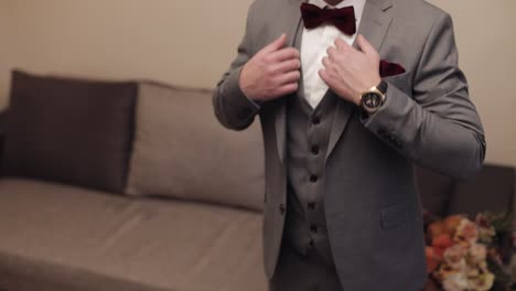 Handsome-groom-businessman-wearing-gray-jacket-at-home-in-living-room,-white-shirt-with-black-tie