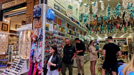 People-in-the-old-town-market-of-athens,-greece,-walking,-pan-left