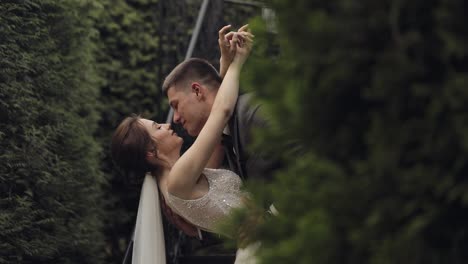 Newlyweds,-caucasian-groom-with-bride-stay-on-stairs-in-park,-wedding-couple,-man-and-woman-in-love